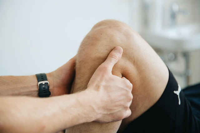 Physiotherapist massaging knee