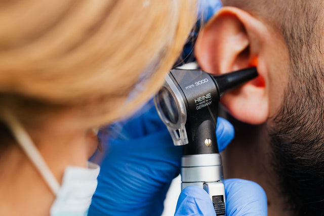 Doctor with otoscope ear exam