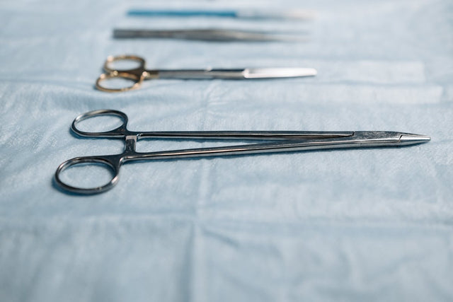 Surgical needle holder on blue cloth